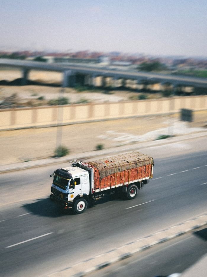 Mastering the First Impression: Your intriguing post title goes here A cargo truck swiftly travels on a highway, emphasizing logistics and speed.